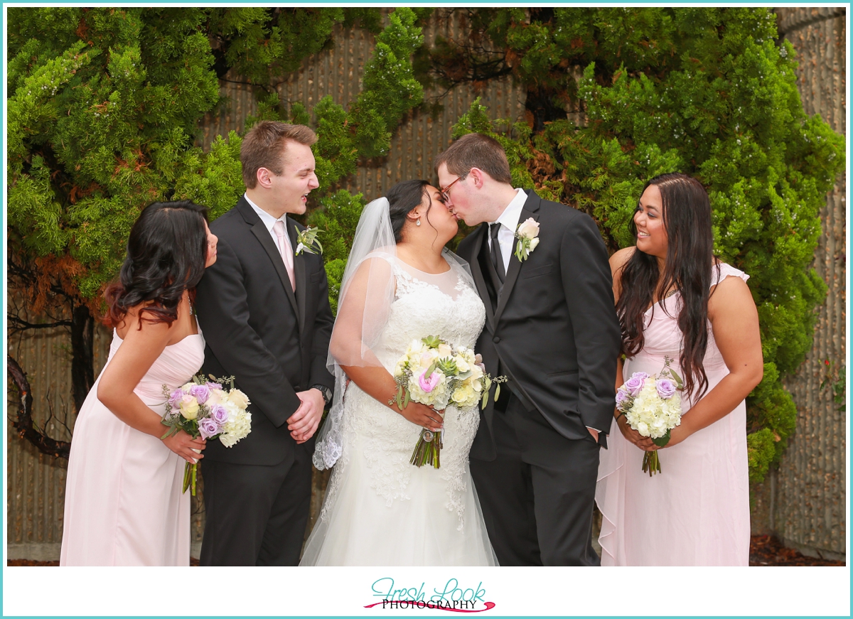 bridal party kissing photo