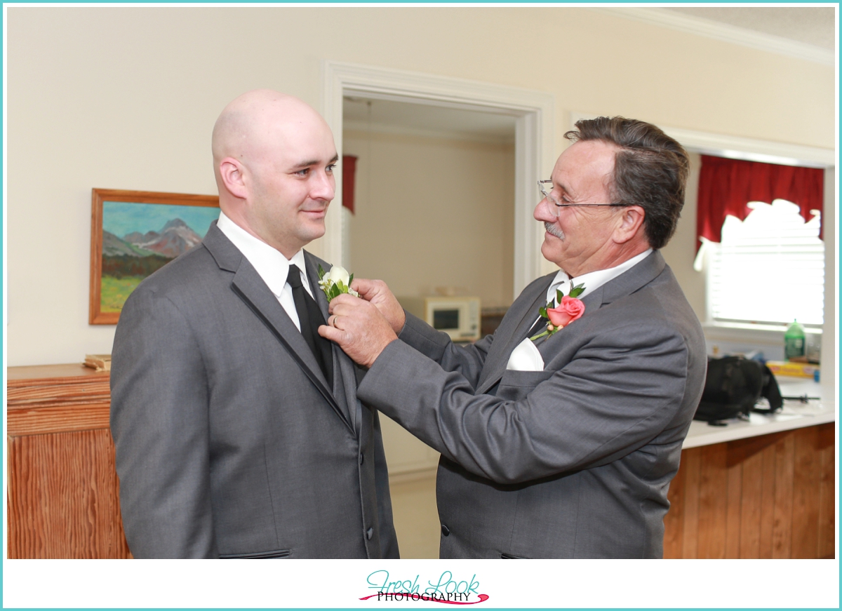 pinning the boutonniere on 
