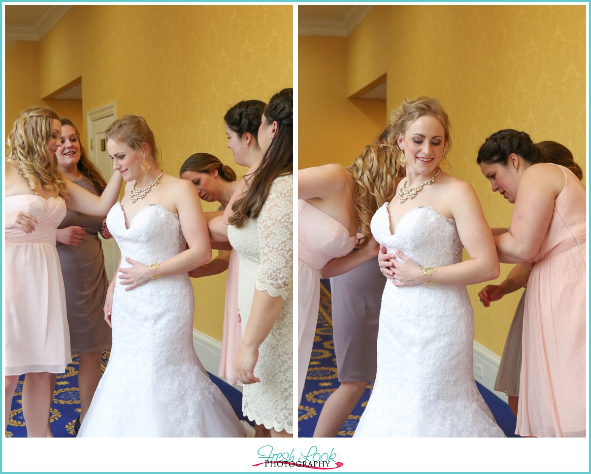 bride putting on dress