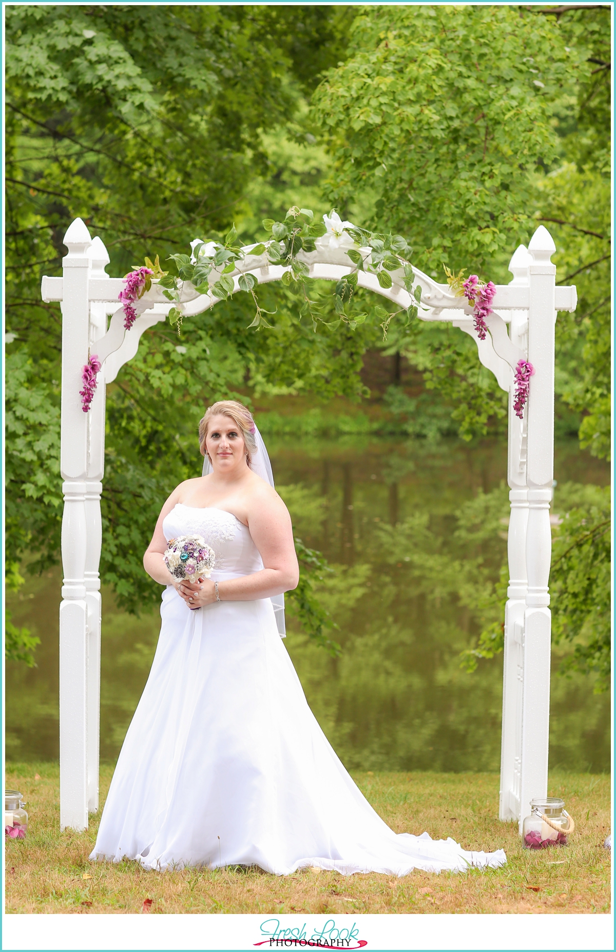 bride under wedding arch