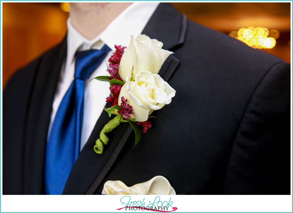 rose and blue boutonniere groom