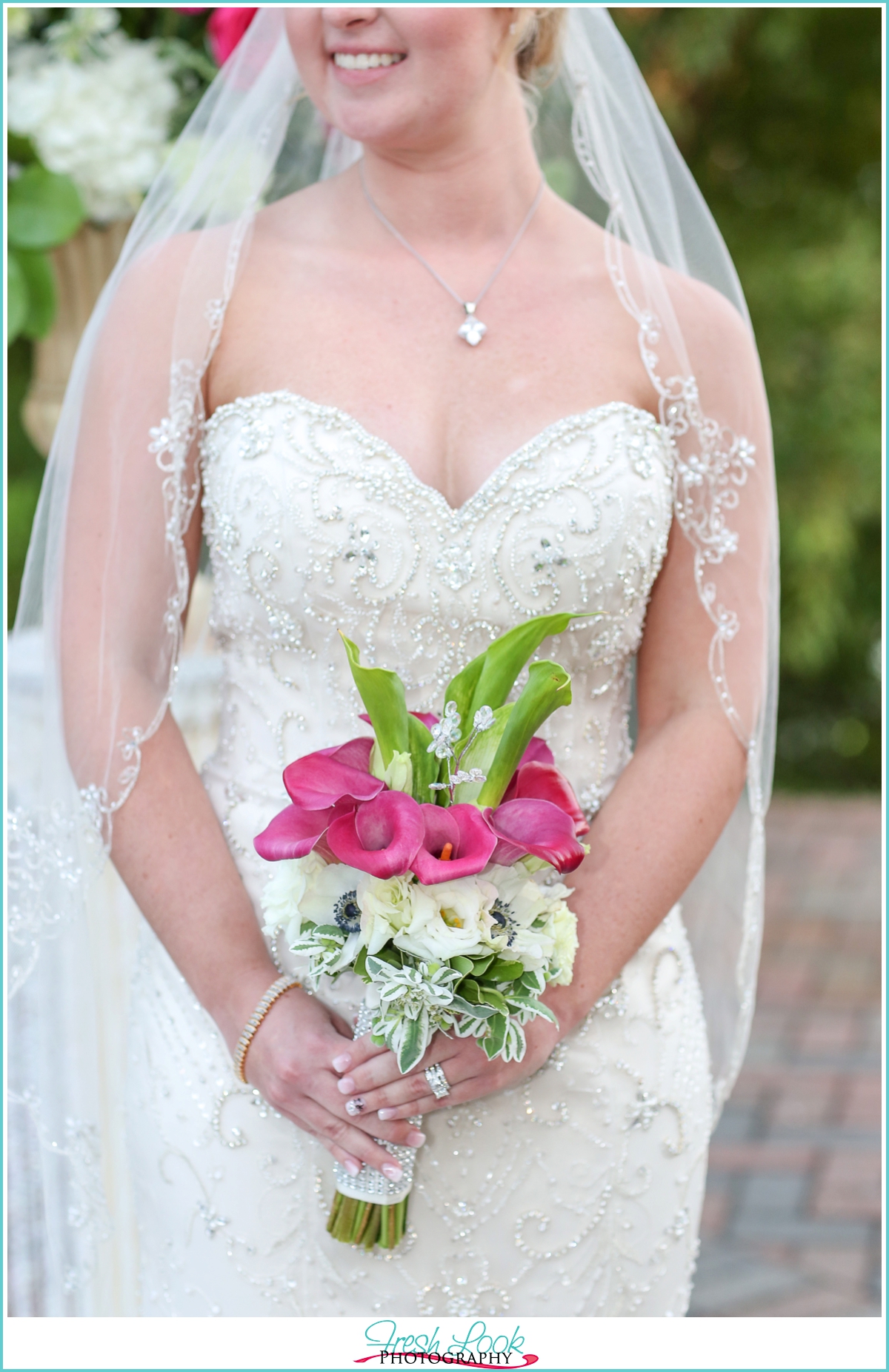 bride holding pink bouquet