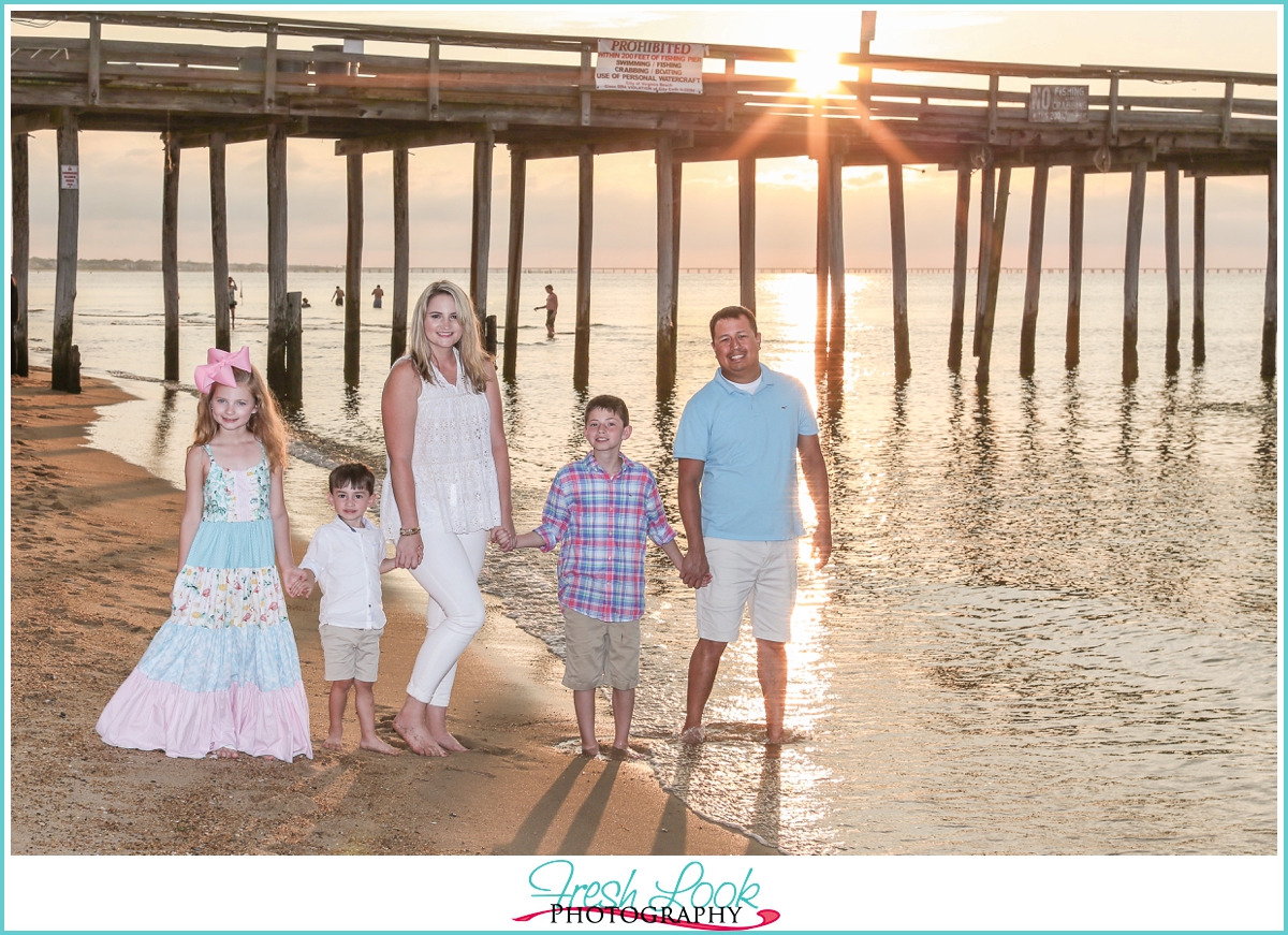 family of five strolling down the beach