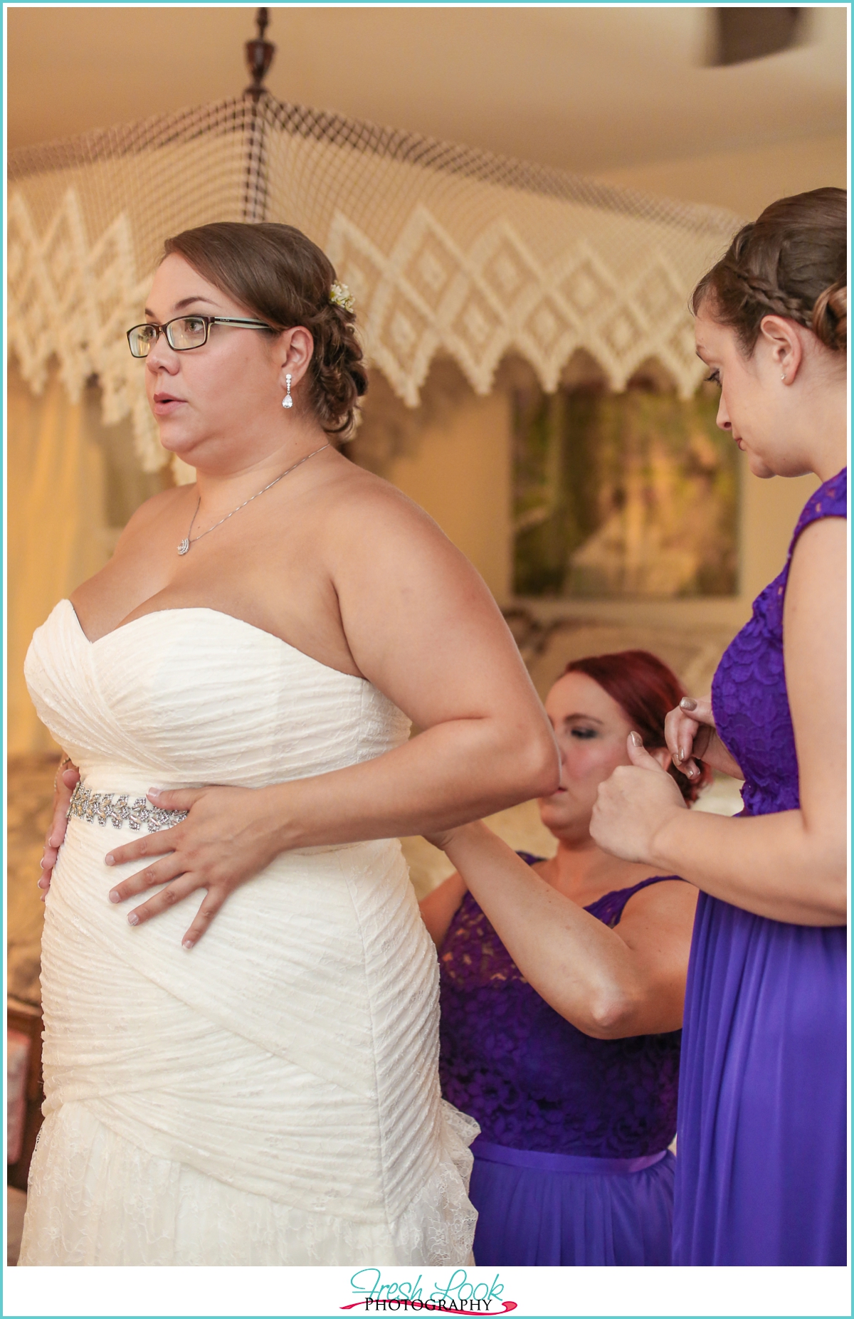 putting on the wedding dress