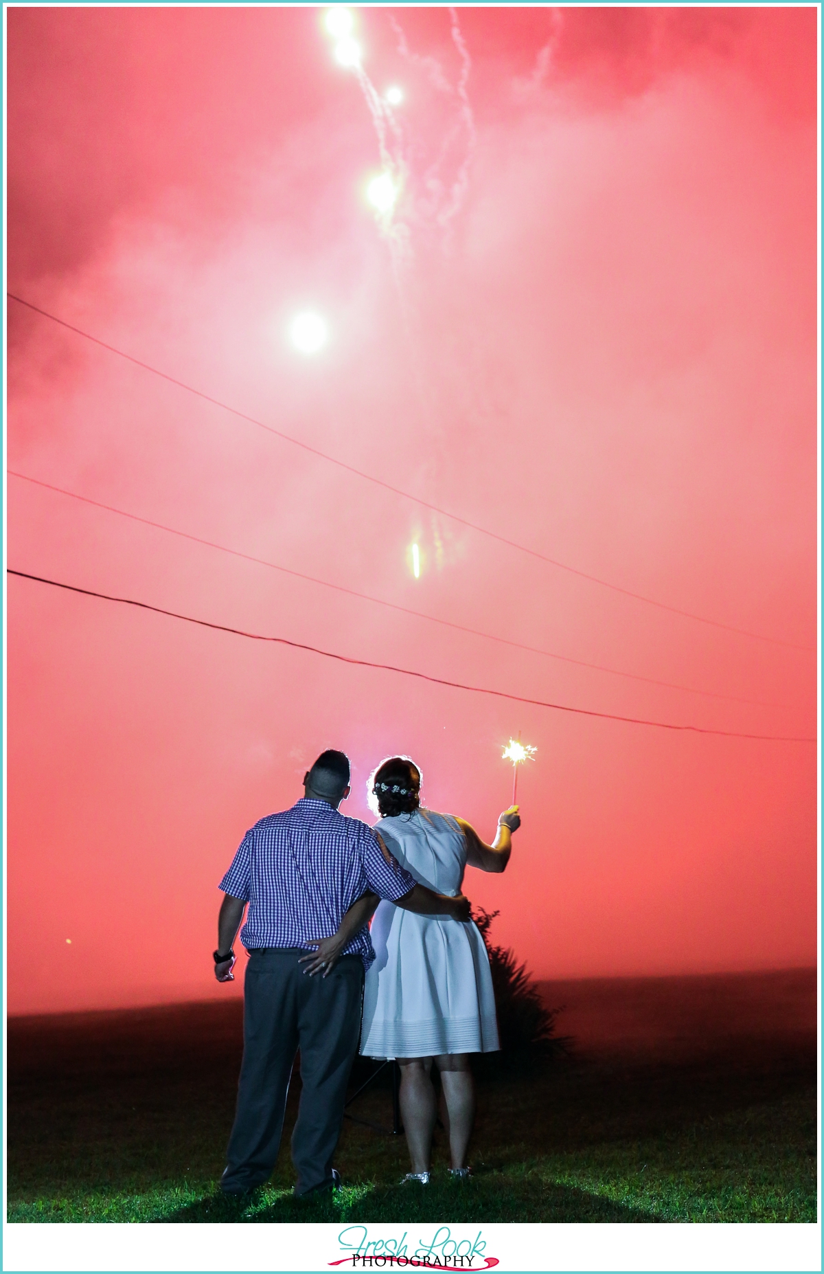 bride and groom enjoying the fireworks