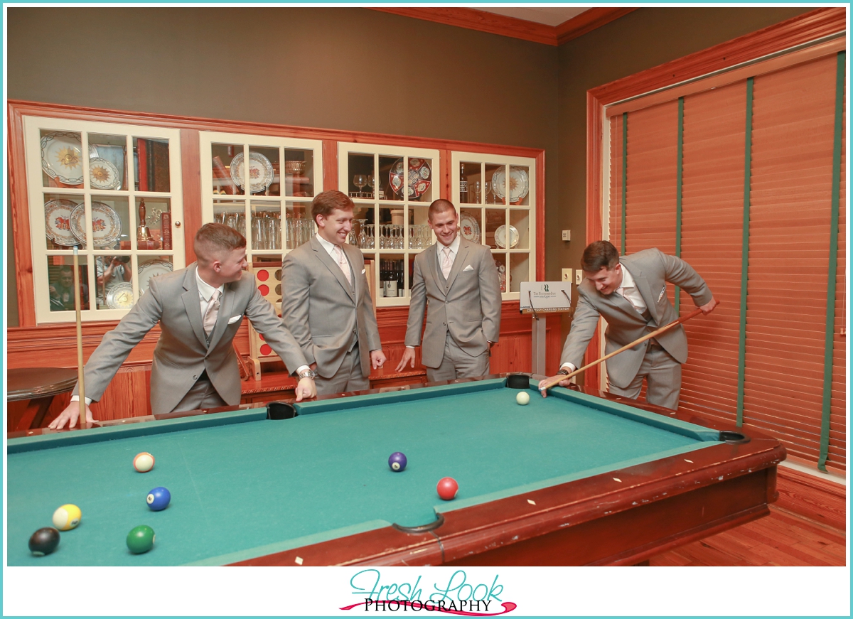 classy groomsmen playing pool