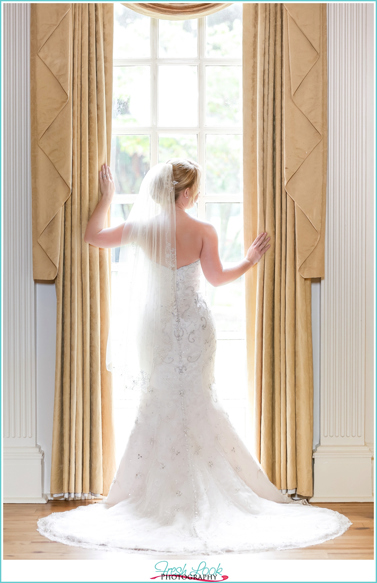 bride standing by the window