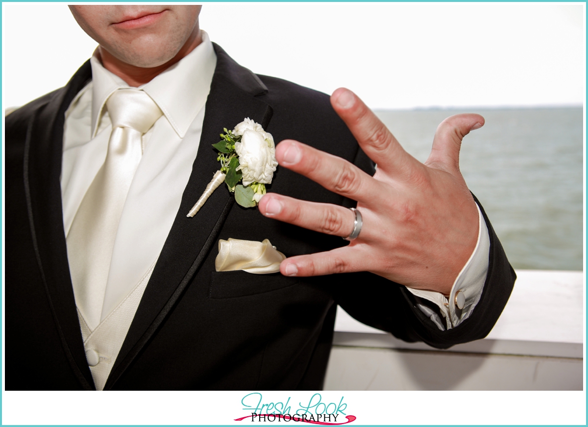 groom showing off wedding ring