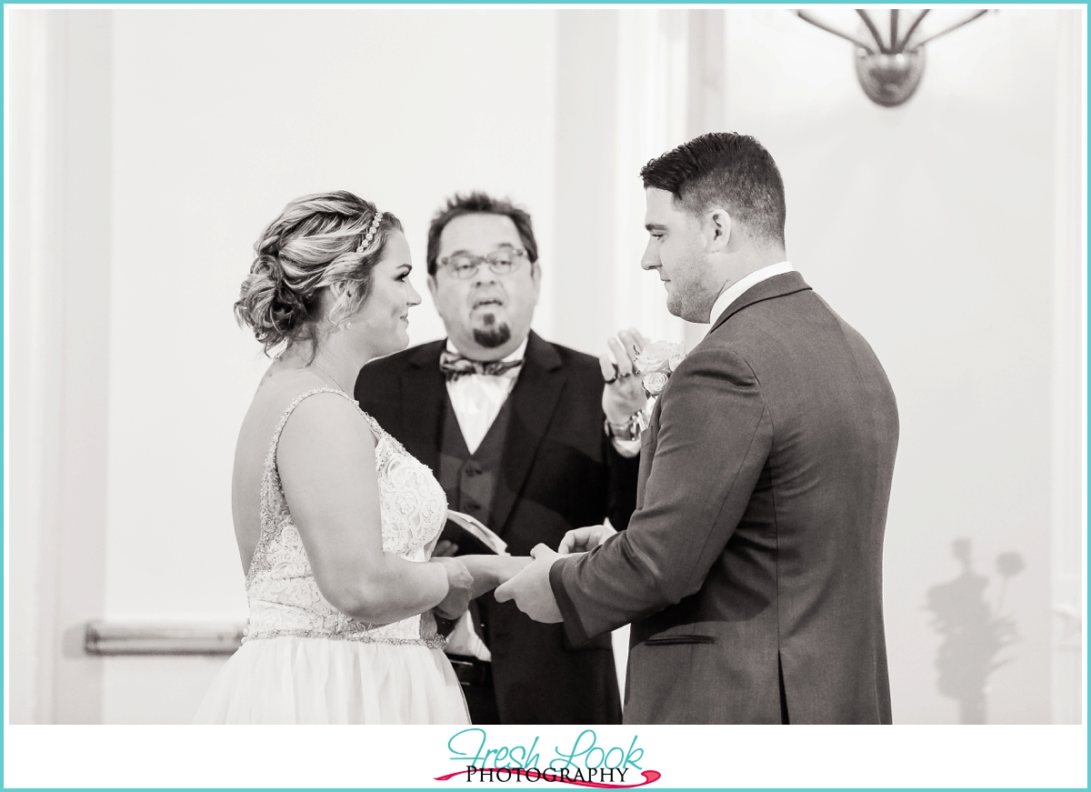 bride and groom exchanging rings during the wedding