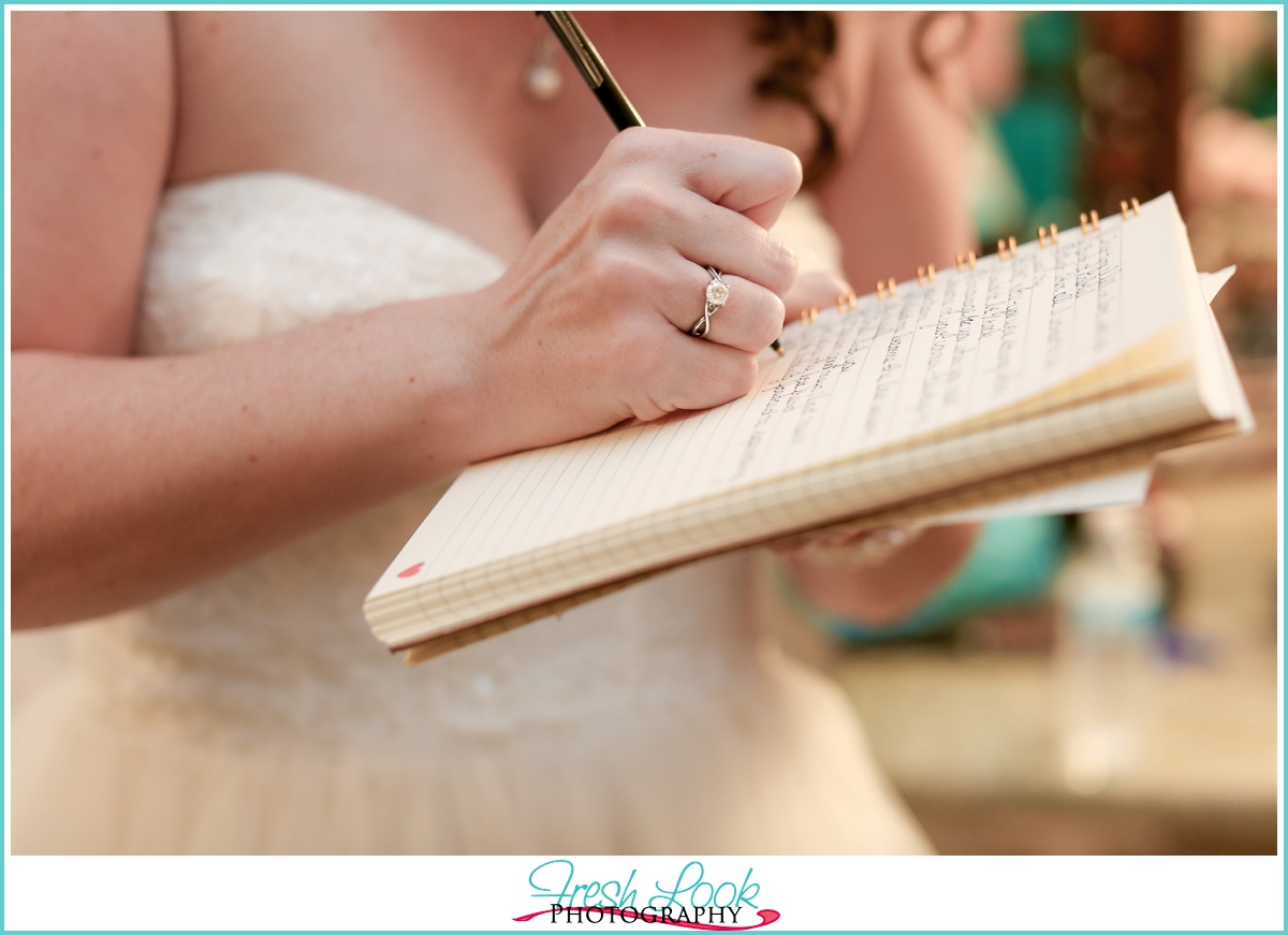 bride writing her vows before the wedding