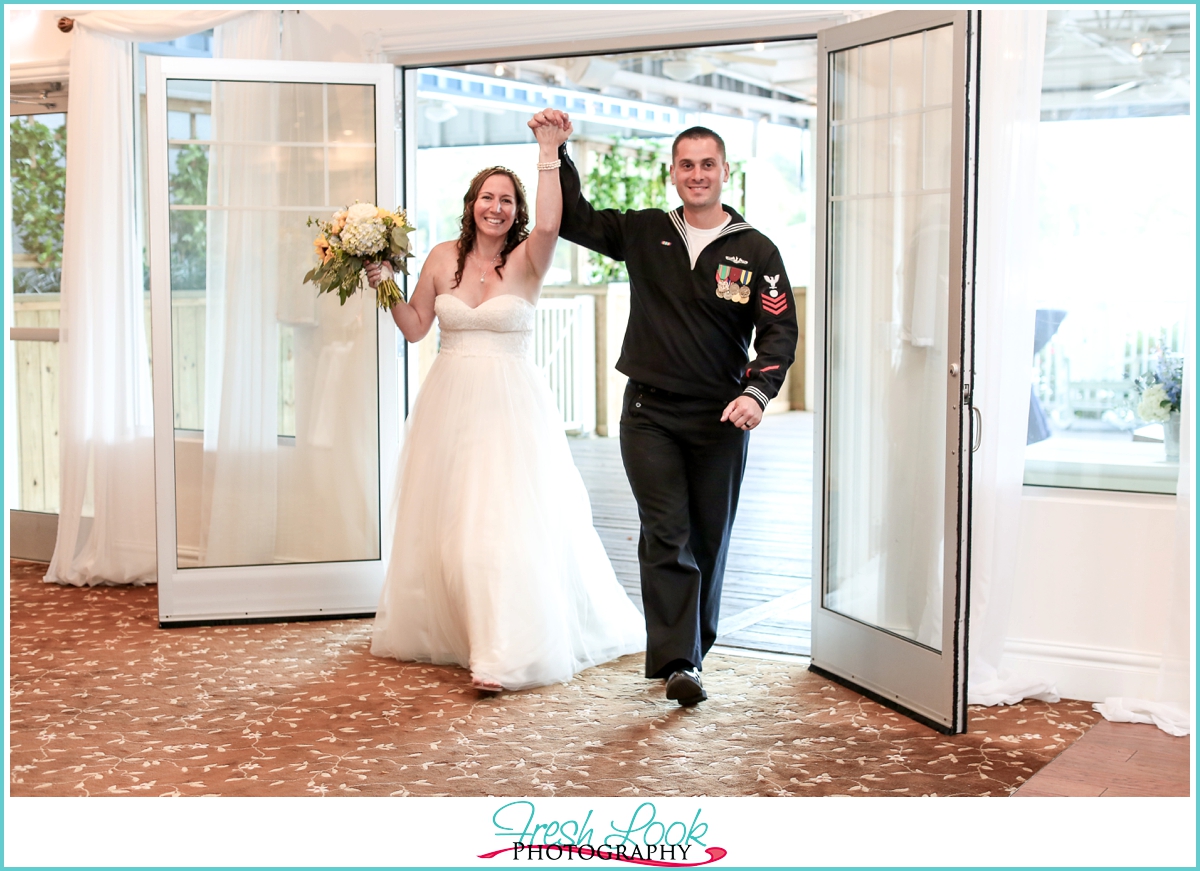 Bride and groom entering wedding reception