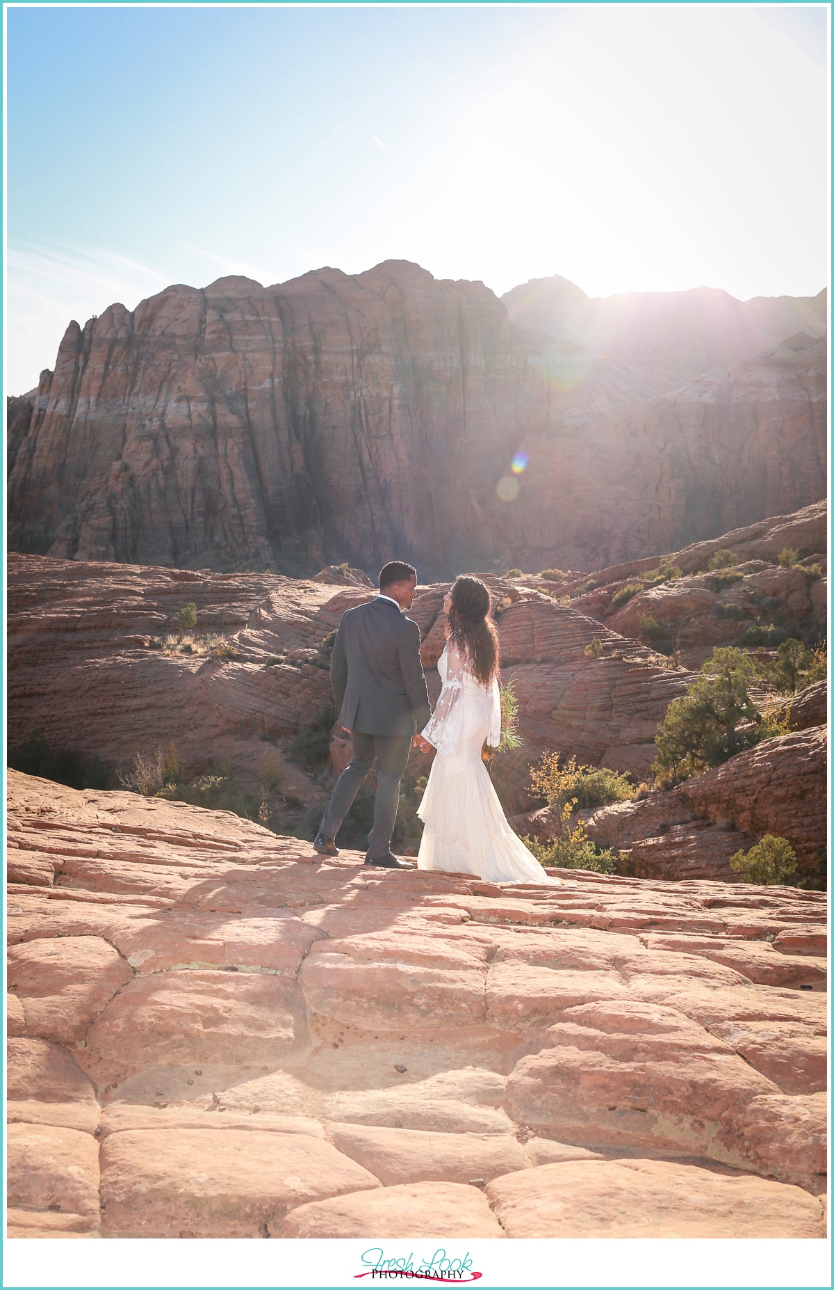 Bride and groom walking in the canyon