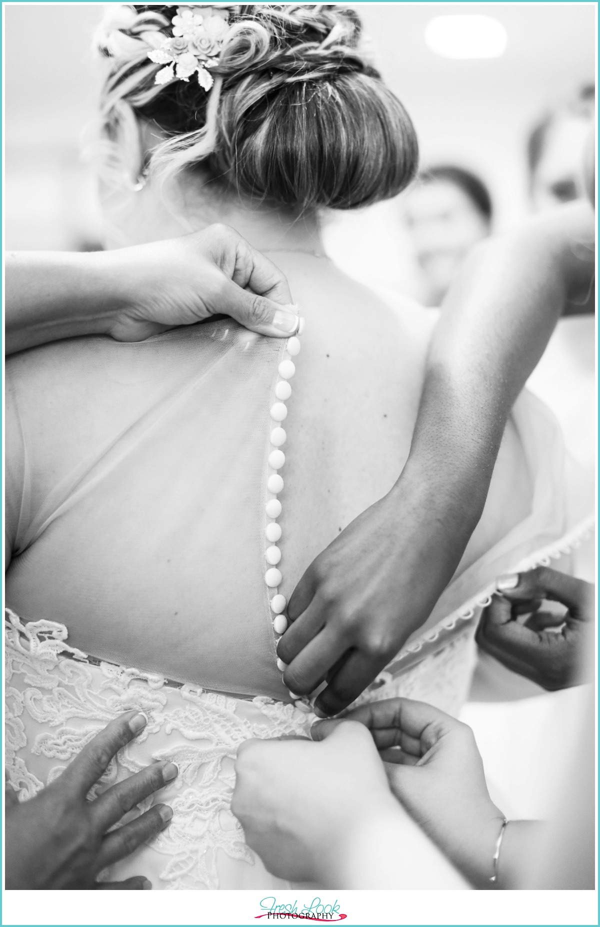 buttoning up the wedding gown