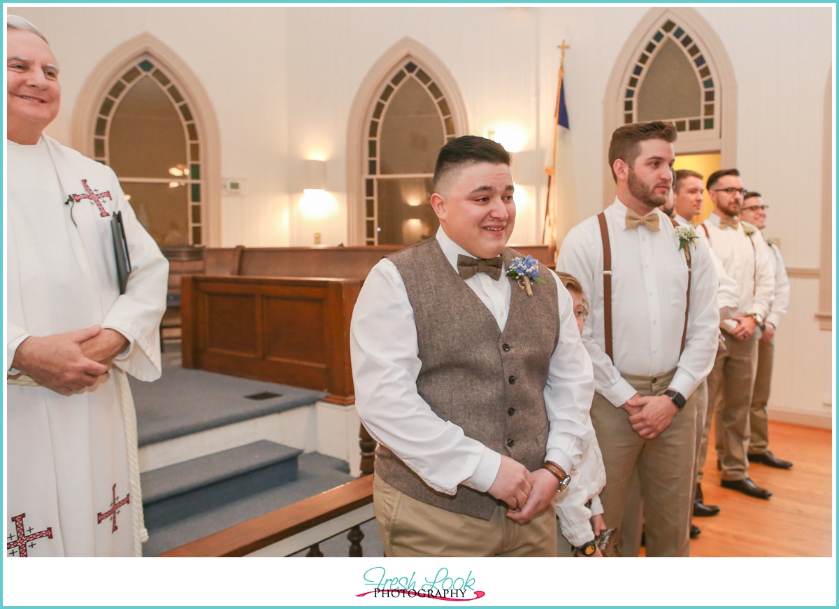 emotional groom waiting at the altar