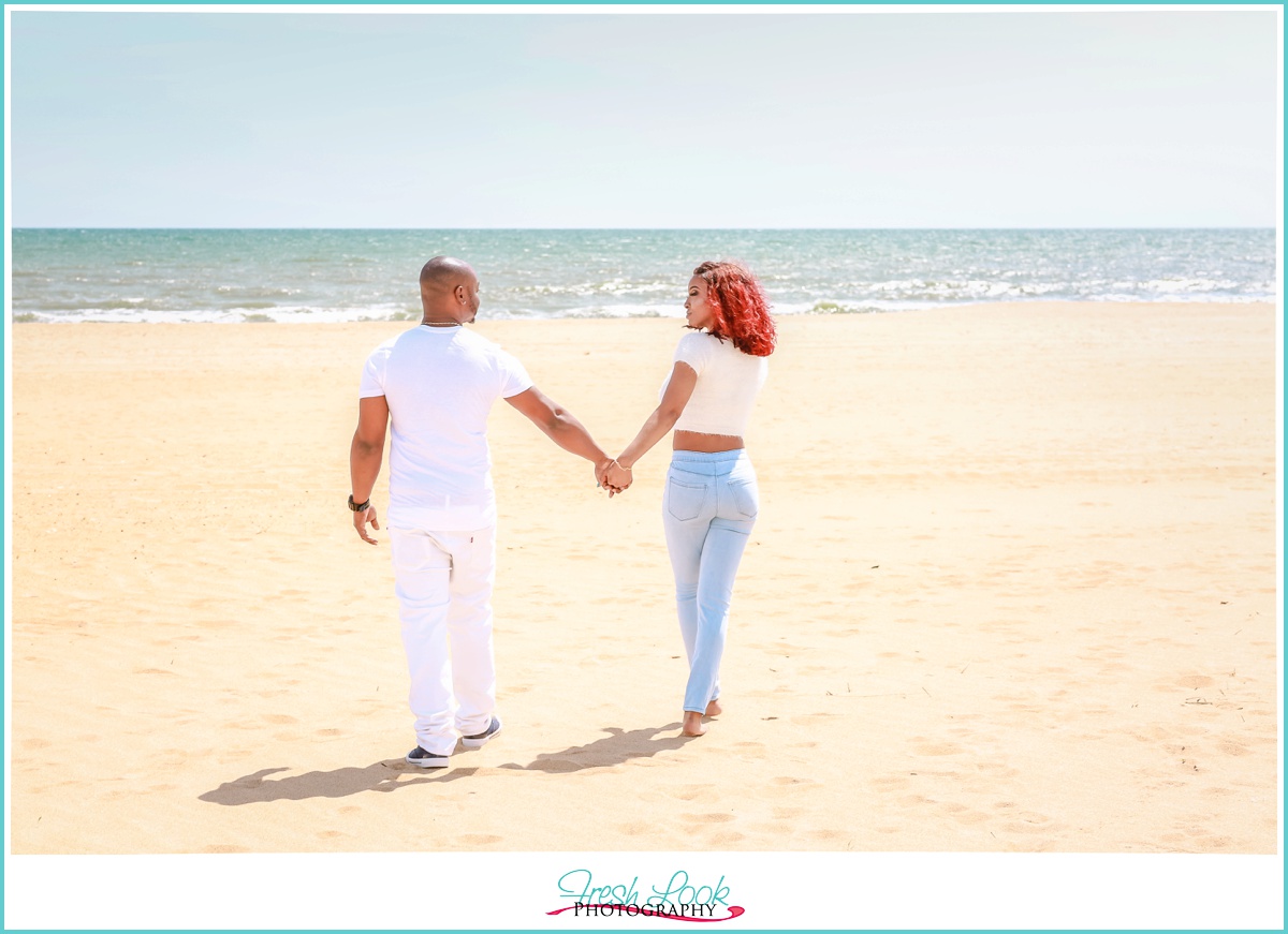 walking hand in hand on the beach