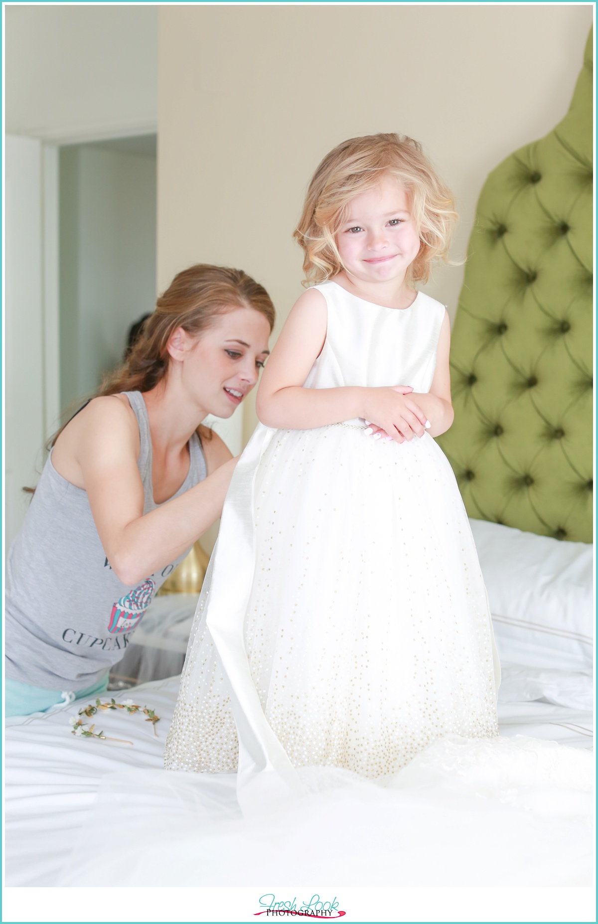 Bride getting flower girl ready