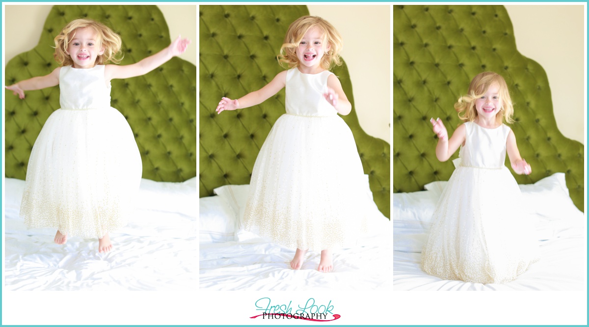 Flower girl jumping on the bed