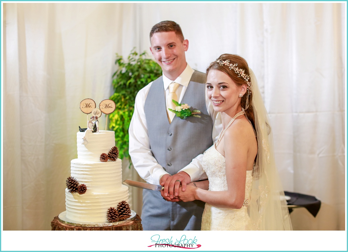 bride and groom cutting the cake