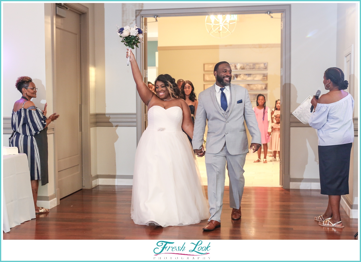 bride and groom entering the reception