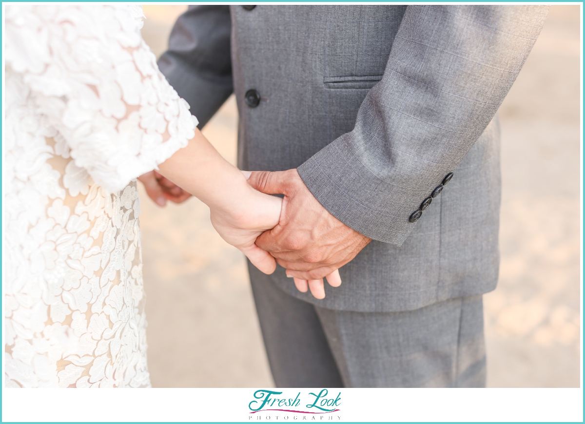 holding hands during tropical wedding ceremony