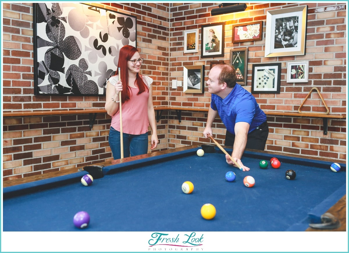 Playing pool at engagement session
