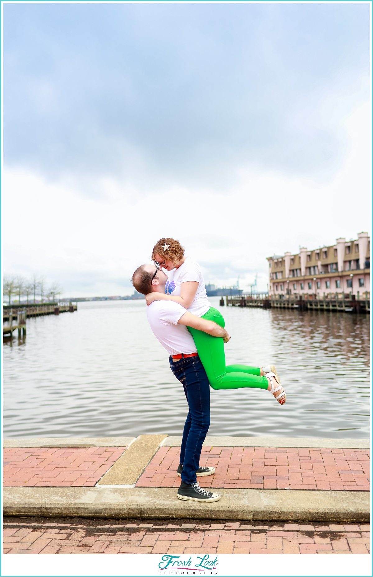 snuggling by the water engagement photo