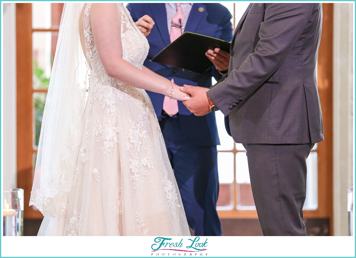 holding hands during the wedding ceremony