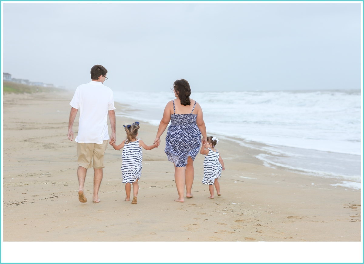 family walking on the beach together