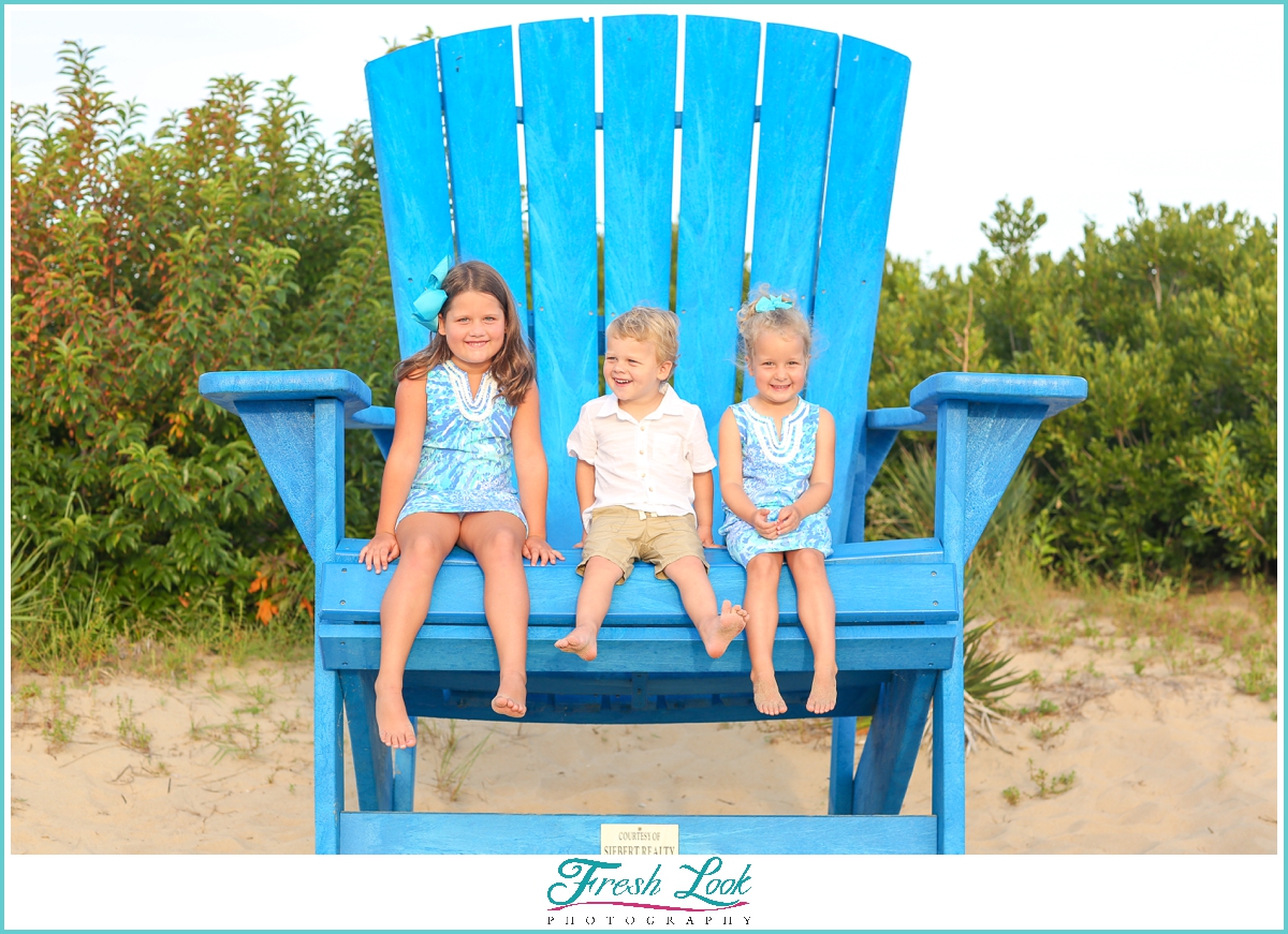 kids sitting in oversized chair in VIrginia Beach