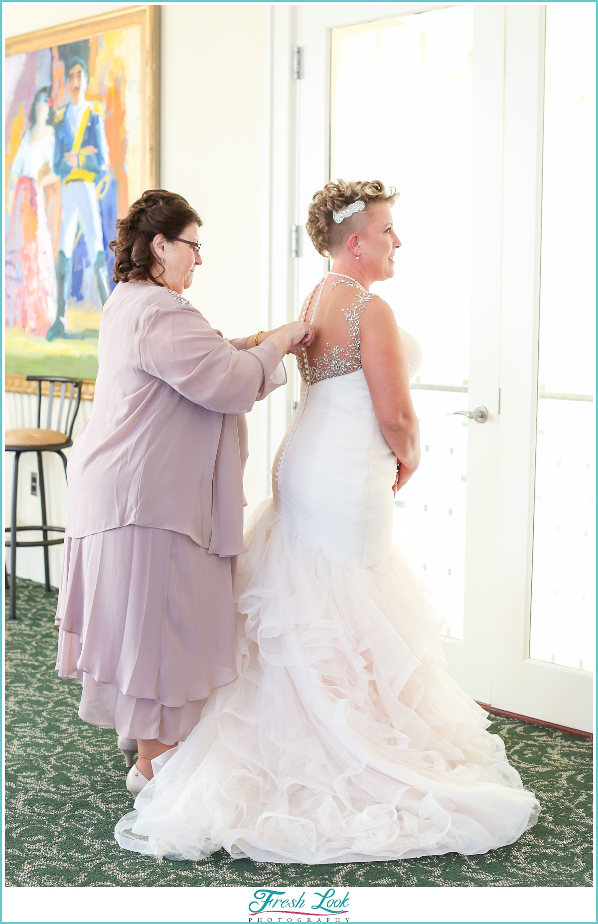 bride getting into wedding dress