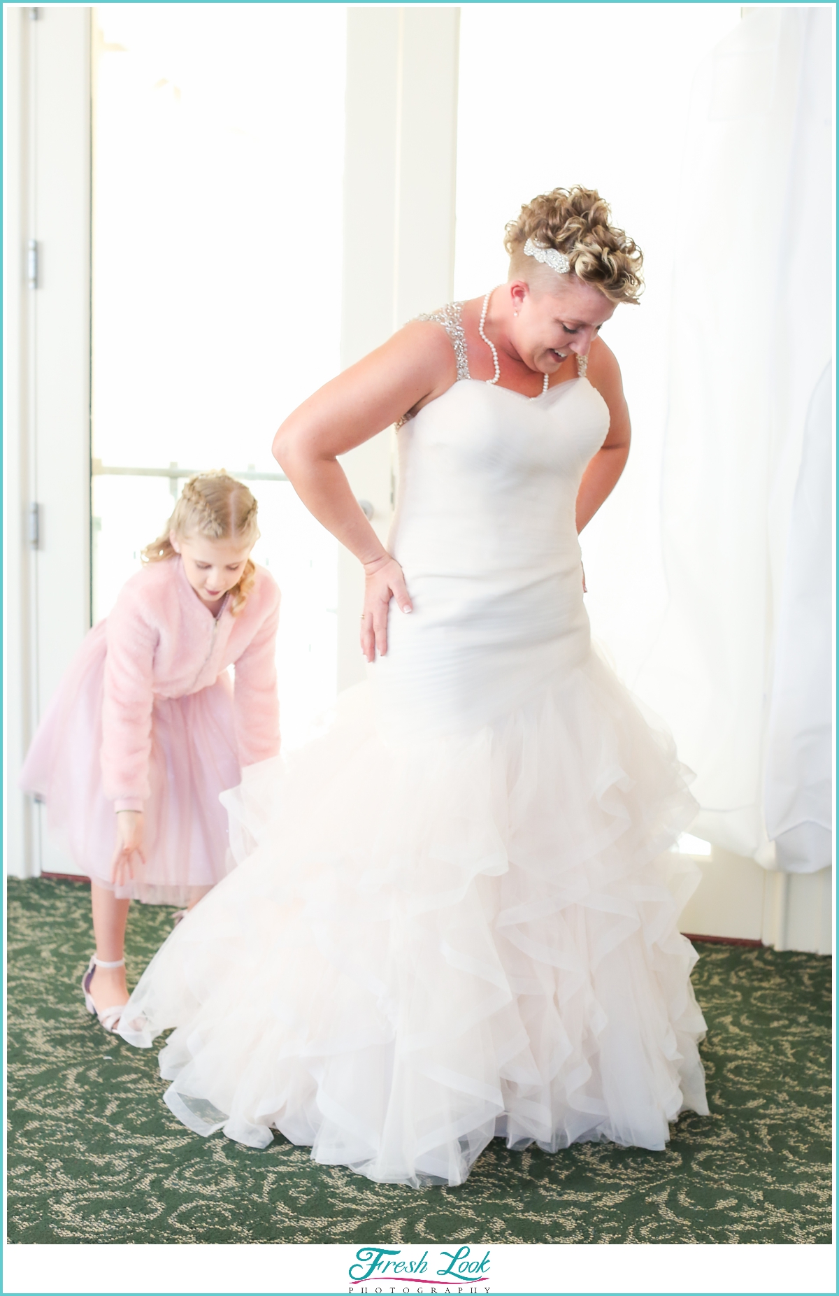 daughter helping bride get ready for the wedding