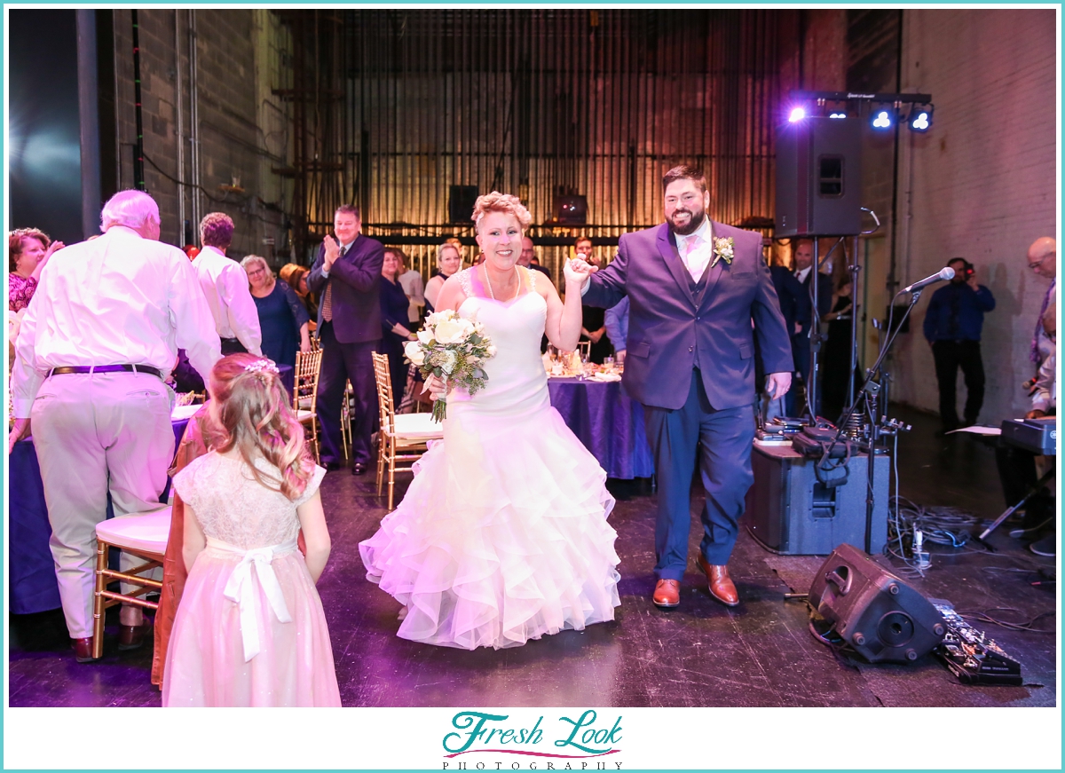 bride and groom entering reception