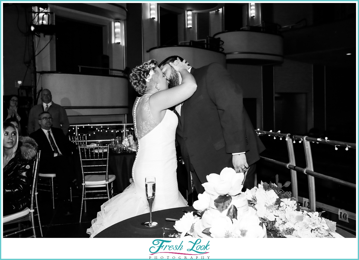 bride and groom kiss at reception