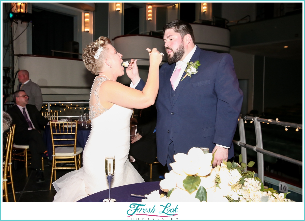 bride and groom feeding each other cake