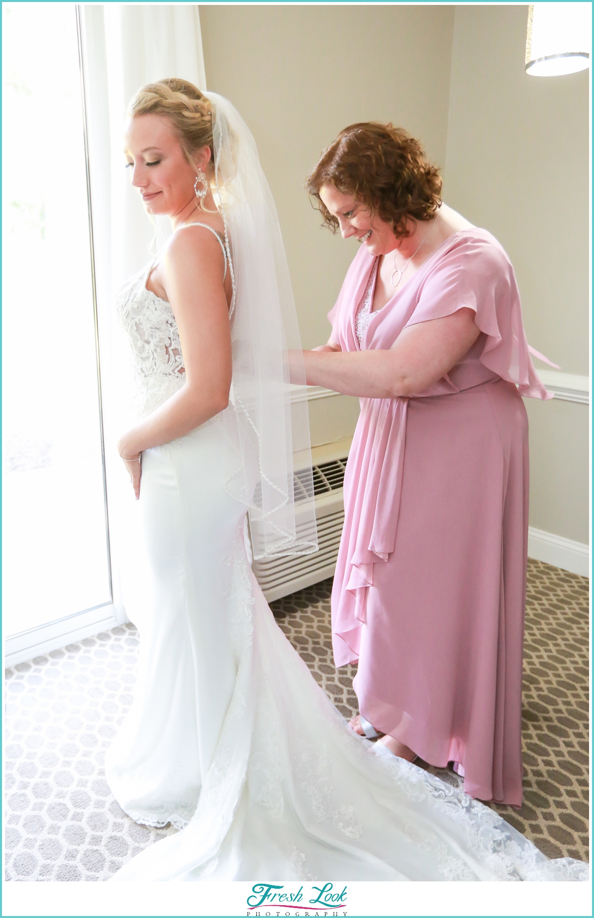 bride getting into wedding dress