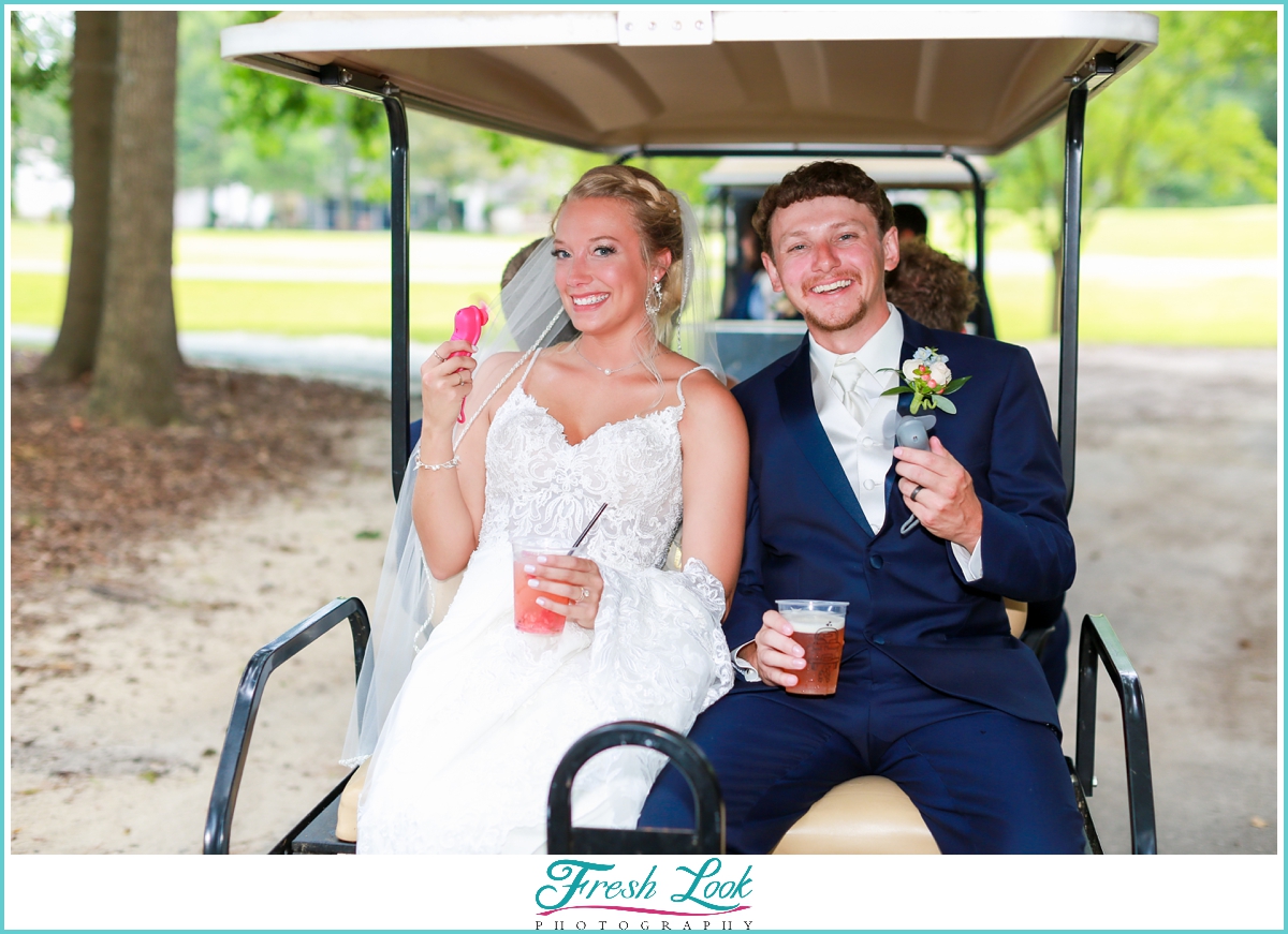 bride and groom in golf cart