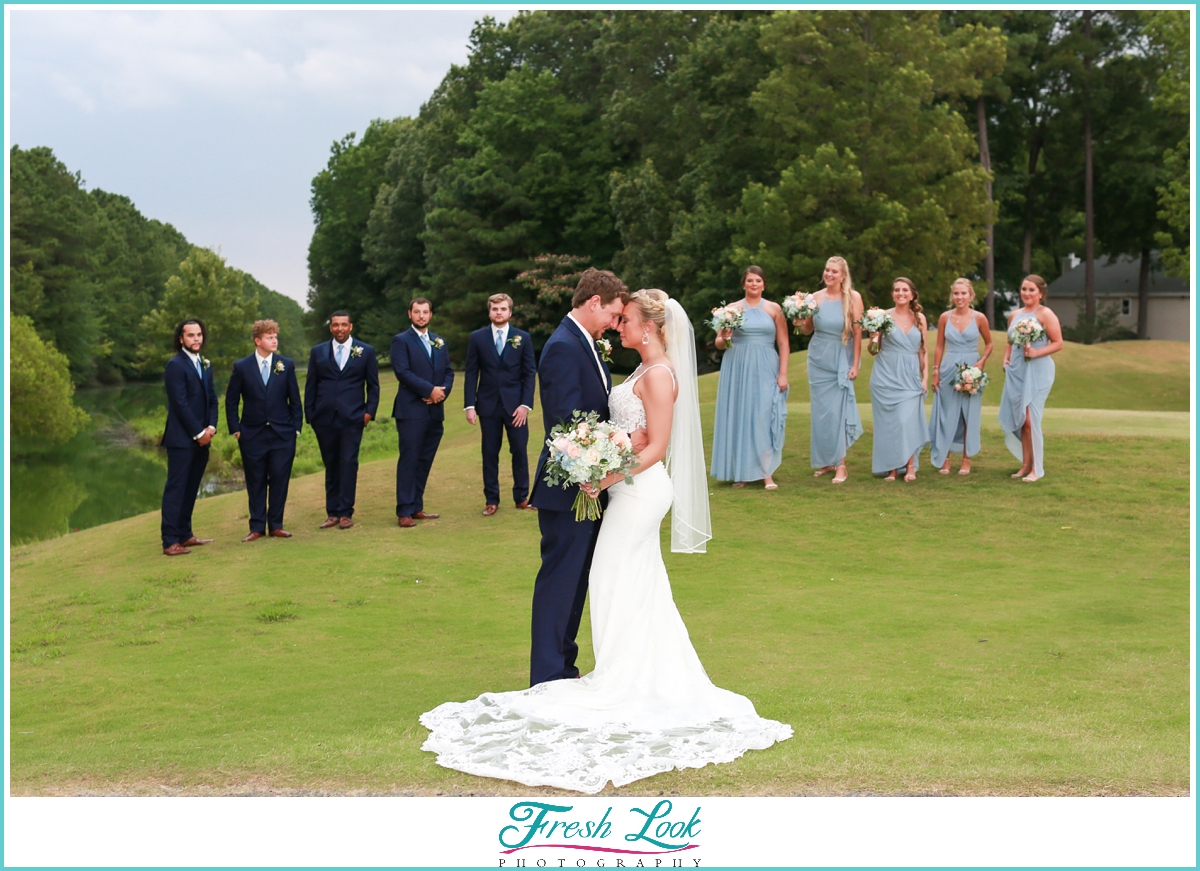 bridal party sneaking up on bride and groom