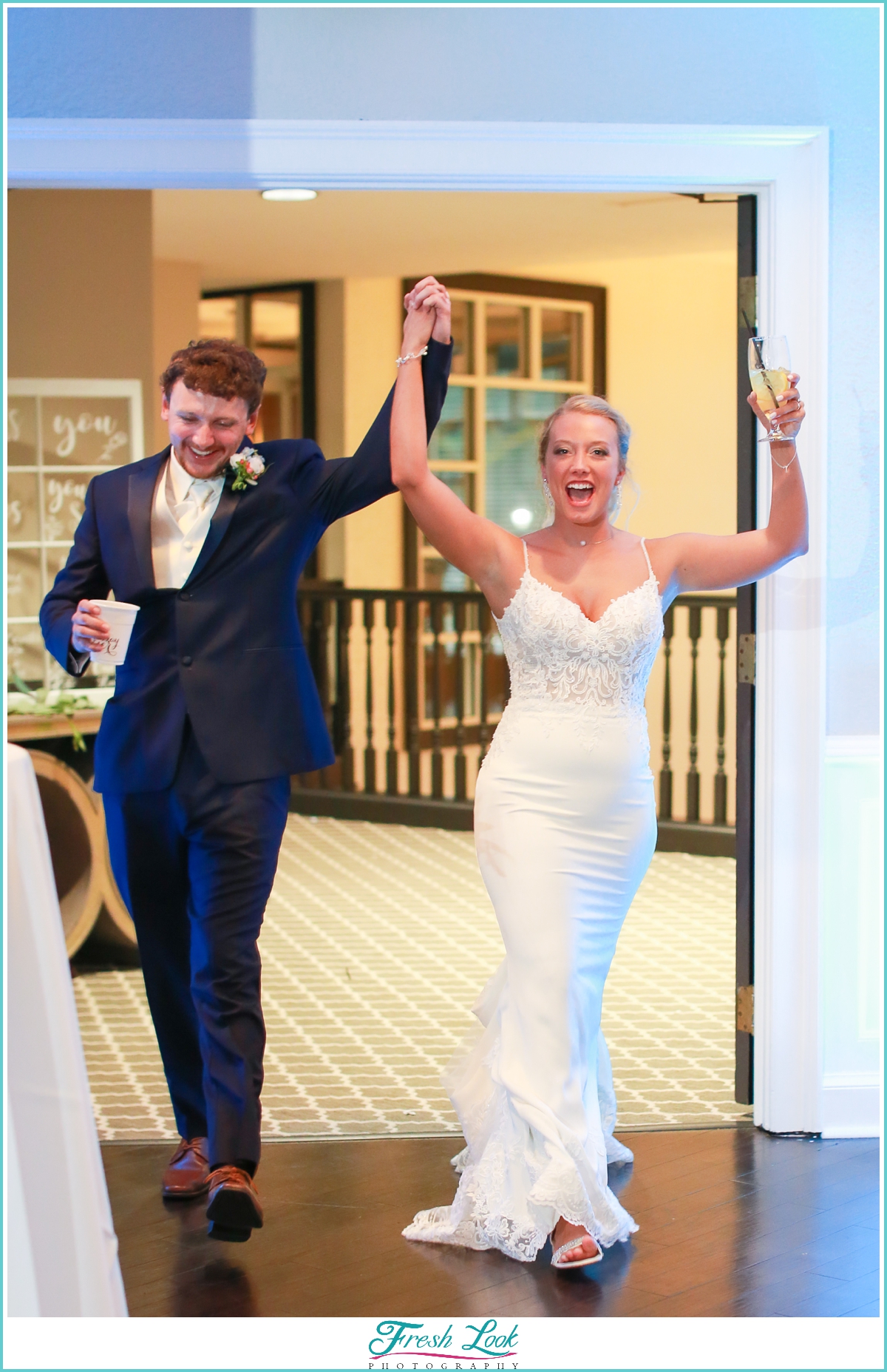 bride and groom entering wedding reception