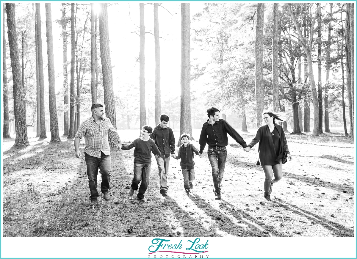 family running through the woods together