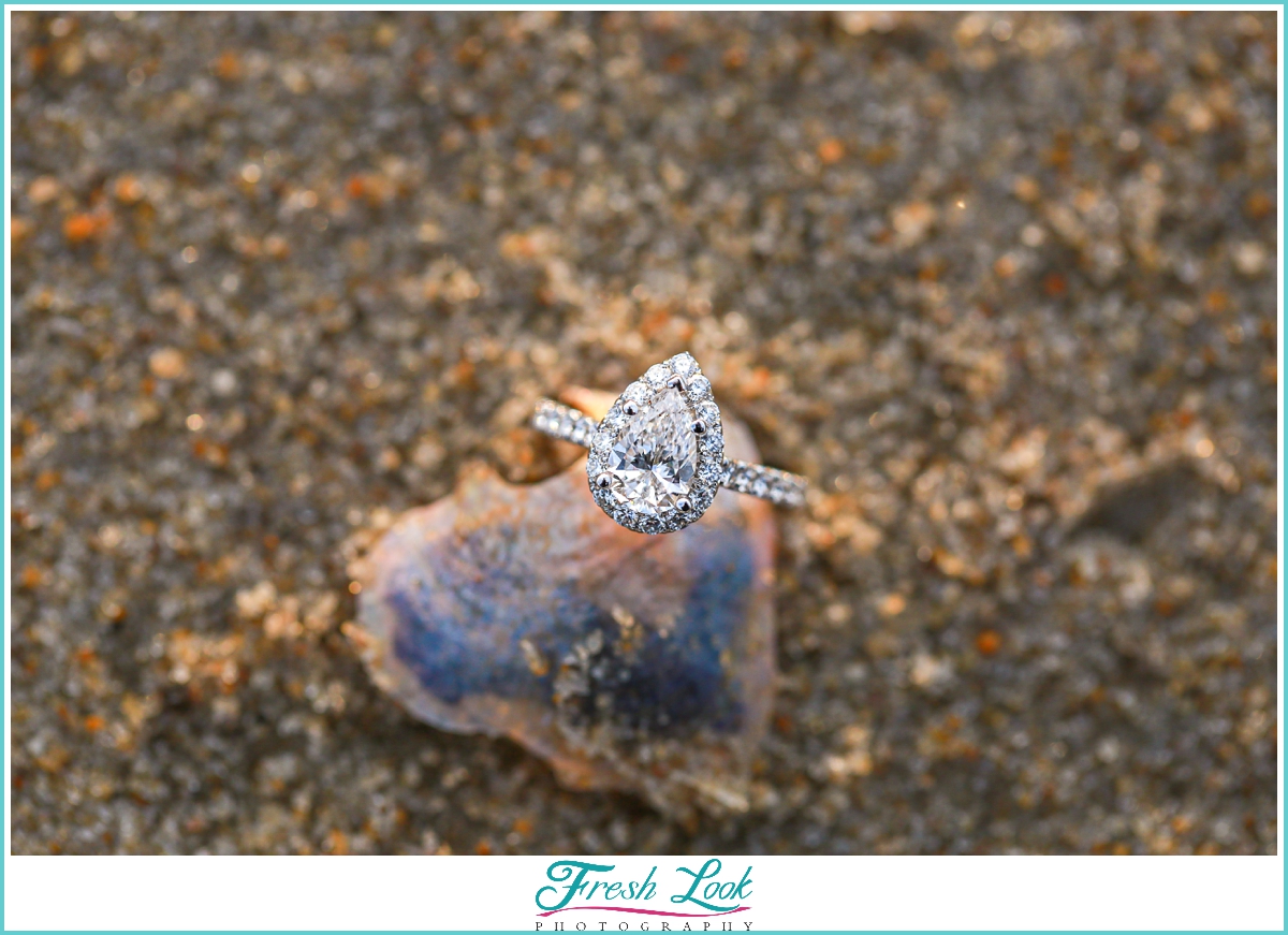 Pear engagement ring on the beach
