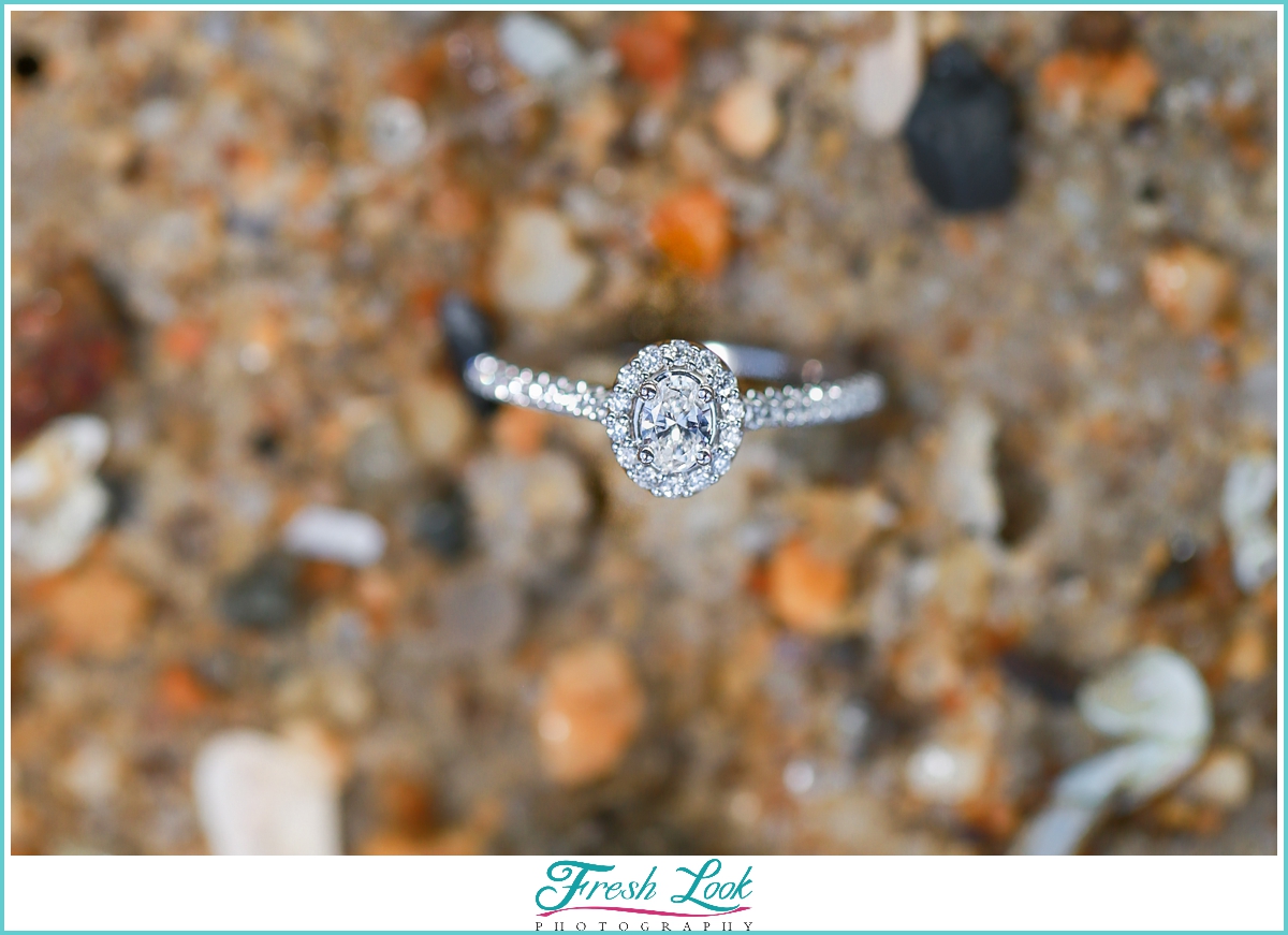 diamond engagement ring in the sand