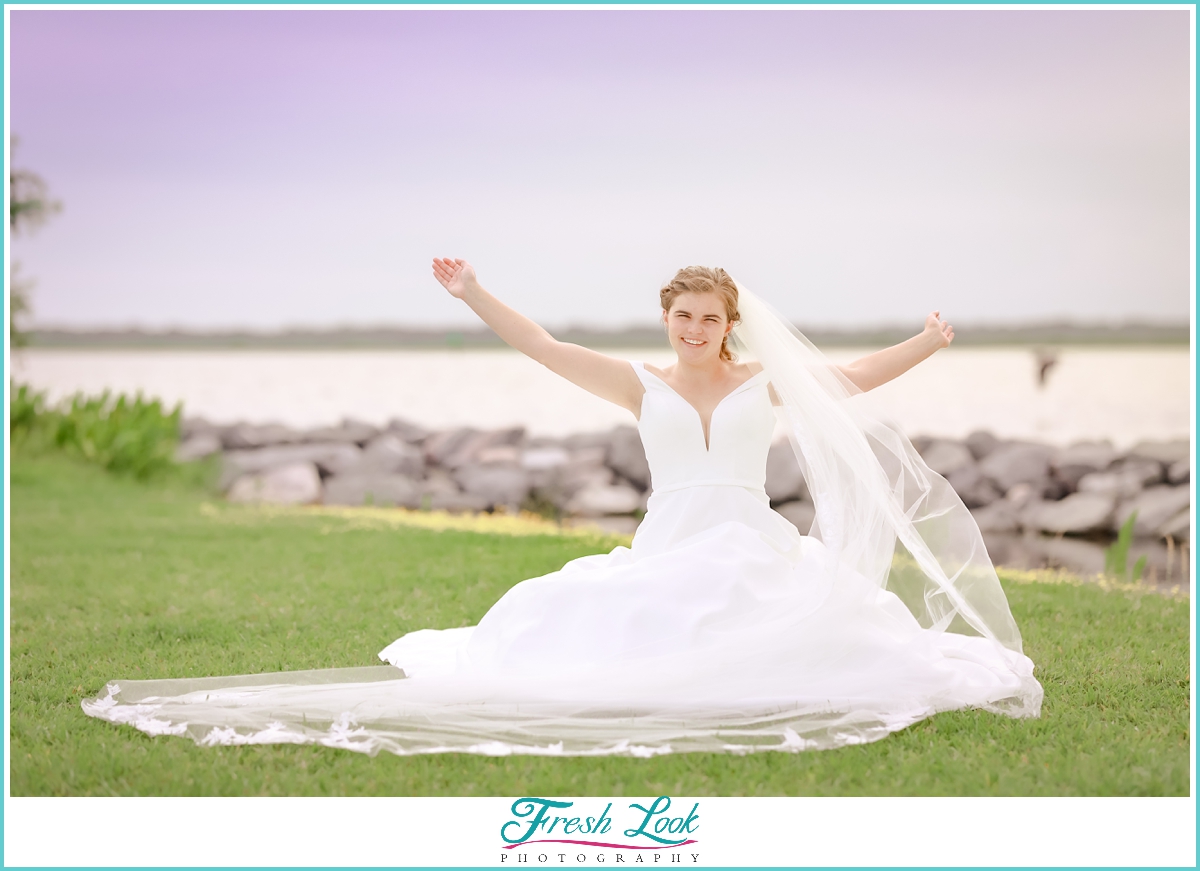 excited bride by the water