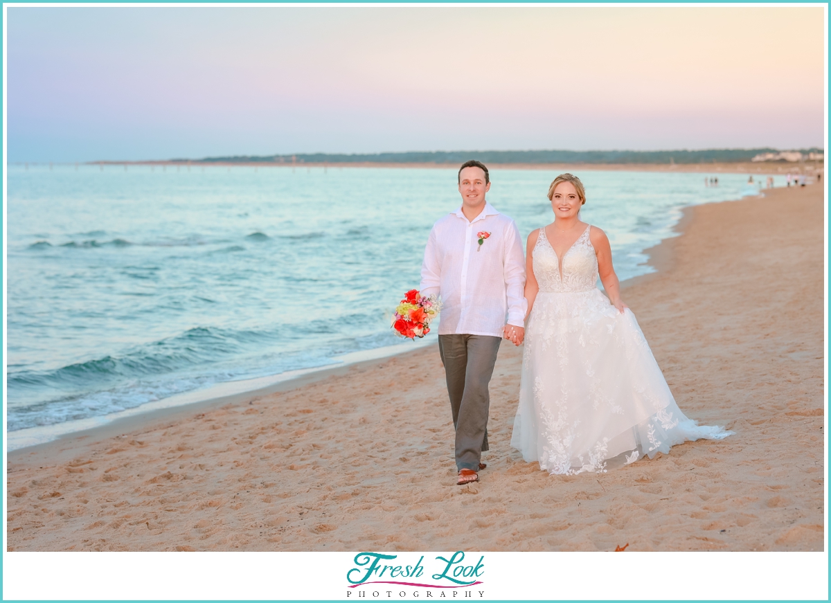 romantic beach walk with bride and groom