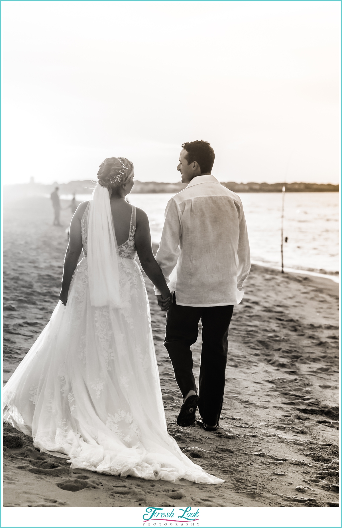 bride and groom walking on the beach