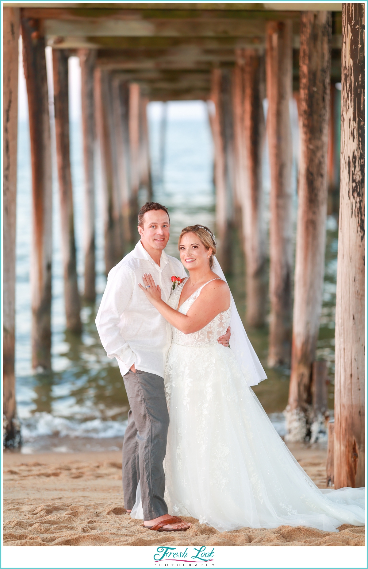 romantic beach portraits under the pier