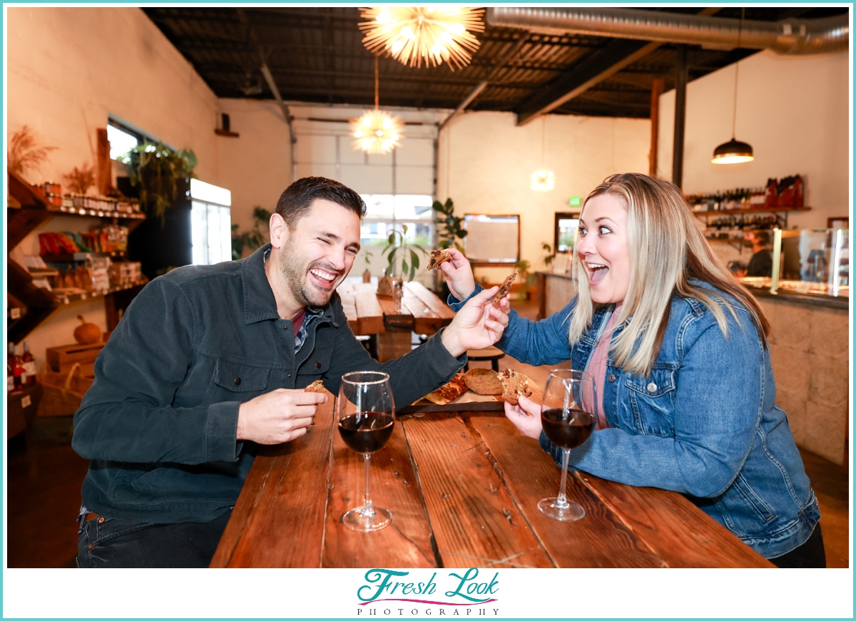 feeding each other cookies during engagement photos