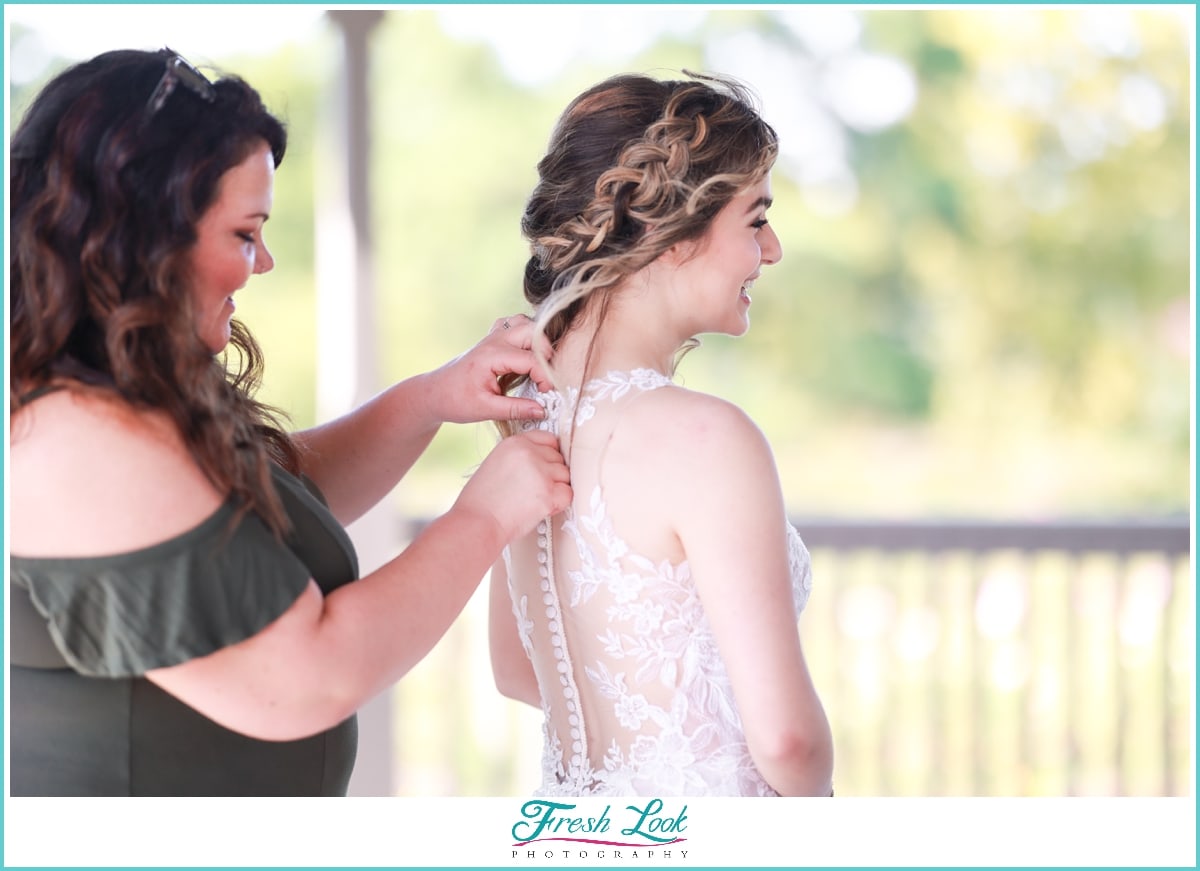 bride getting into wedding dress